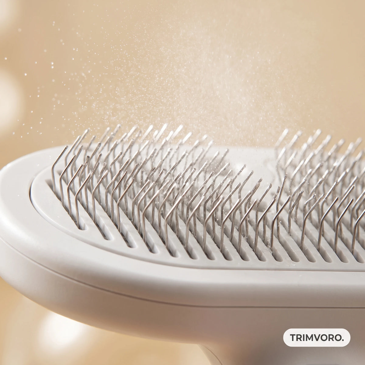 Close up of a white comb's metal pins with a fine water mist in the air